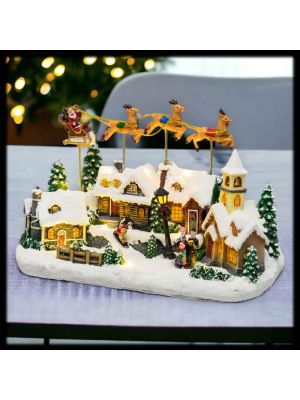 Villaggio di Natale con chiesa e Babbo Natale su slitta volante con musiche, h 23 cm